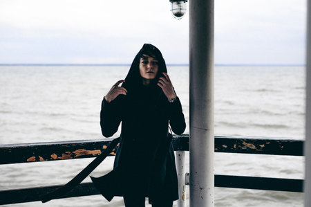 fashionable portrait of a young brunette woman in black clothes, jeans T-shirt, coat and sunglasses,...