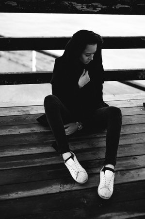 fashionable portrait of a young brunette woman in black clothes, jeans T-shirt, coat and sunglasses,...