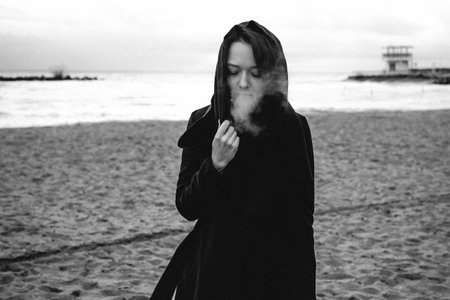 fashionable portrait of a young brunette woman in black clothes, jeans T-shirt, coat and sunglasses,...