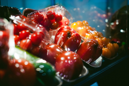 tomatoes and cucumbers in a vacuum-packed in the storefrontの写真素材