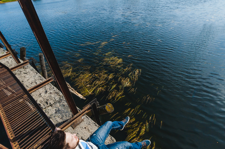 young man with a beard. a trip to the lake, an abandoned old dam, a warm sunny dayの写真素材