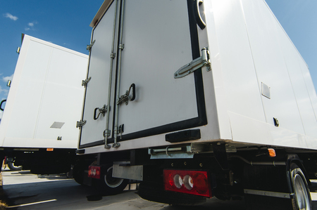 vehicles for cargo transportation business. trucks small and medium-duty trucks. new working cars cargo vans of white colorの写真素材
