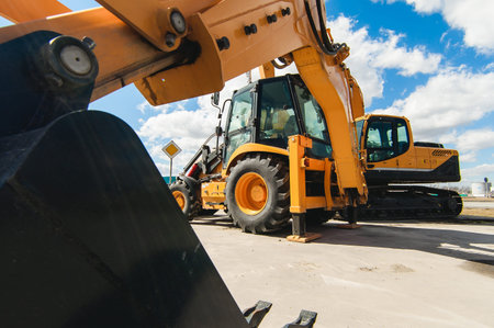 road-building machinery, tractors yellow excavators in the open air in working position
