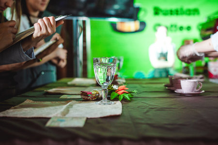 business woman makes notes on a sheet in a notebook, at a restaurant art contest, at a championship...