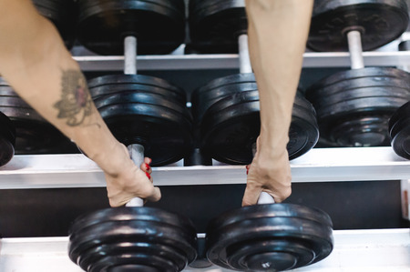 beautiful sexy woman of athletic build, engaged in workouts in gym, physical training of body. Healthy lifestyle concept. motivation and energy chargeの写真素材