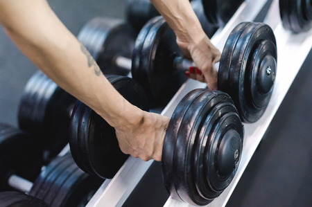 beautiful sexy woman of athletic build, engaged in workouts in gym, physical training of body. Healthy lifestyle concept. motivation and energy chargeの写真素材
