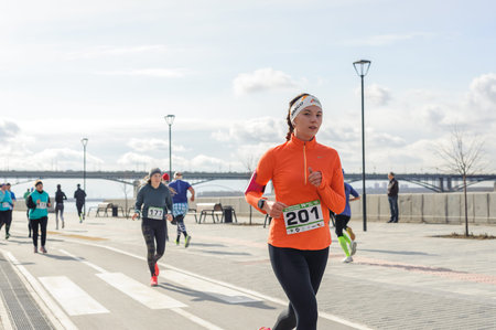 Russia, Novosibirsk - December 14, 2019: Spring Run on the Quay. group of people participate in a...