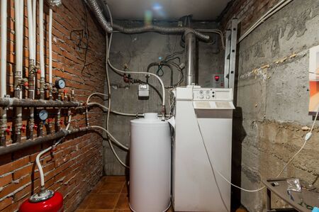Russia, Moscow- June 12, 2019: interior room apartment. standard repair decoration in hostel. boiler room. heating system, pipes and appliancesのeditorial素材