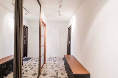 Russia, Moscow- July 06, 2019: interior room apartment. standard repair decoration in hostel. corridor, hallway doors and mirrorsのeditorial素材
