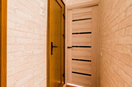 Russia, Omsk- August 02, 2019: interior room apartment. standard repair decoration in hostel. room doors, repair corridorのeditorial素材