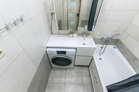 Interior of a bathroom with a washing machine in a modern house