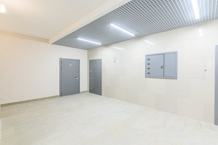 Interior of a room with elevator doors and white tile floor