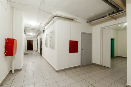 Interior of a corridor with white walls and tiled floor