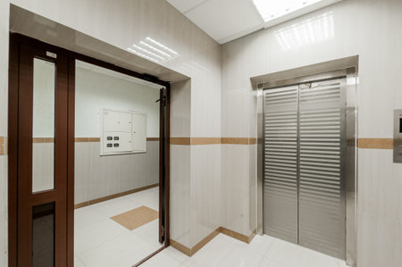 Interior of a hotel room with elevator, door and blinds