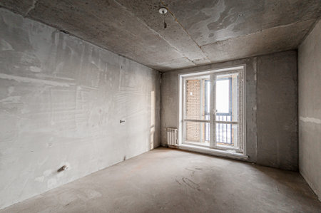 interior of a new apartment without decoration in gray colors with windows