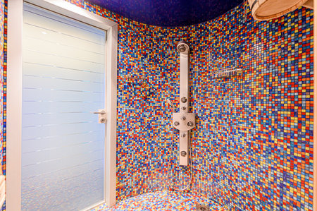 Bathroom interior with blue and orange mosaic tile wall and showerの写真素材