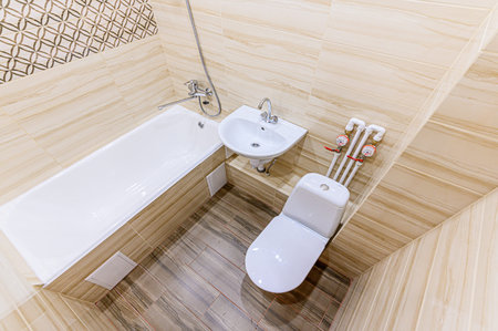 Interior of a modern bathroom with ceramic tiles and toilet. Nobody inside