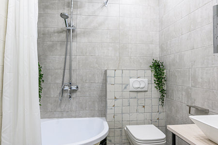 Interior of a modern bathroom with white tiles, shower and toiletの写真素材