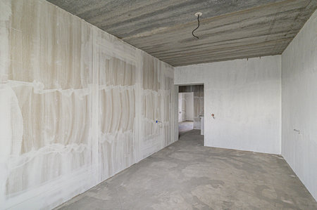 rough repairs for self-finishing. interior decoration, bare walls of the room, stage of construction. interior apartment roomの写真素材