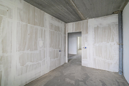 rough repairs for self-finishing. interior decoration, bare walls of the room, stage of construction. interior apartment roomの写真素材