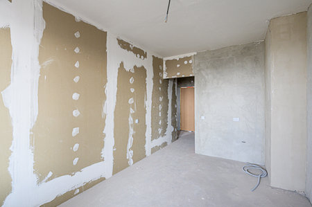 rough repairs for self-finishing. interior decoration, bare walls of the room, stage of construction. interior apartment roomの写真素材