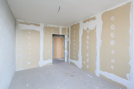 rough repairs for self-finishing. interior decoration, bare walls of the room, stage of construction. interior apartment roomの写真素材