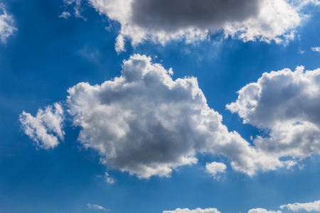 blue sky with white fluffy cloudの写真素材