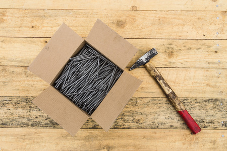 box with metal nails and hammerの写真素材