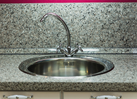 silver plated with a silver faucet in the kitchen sinkの写真素材