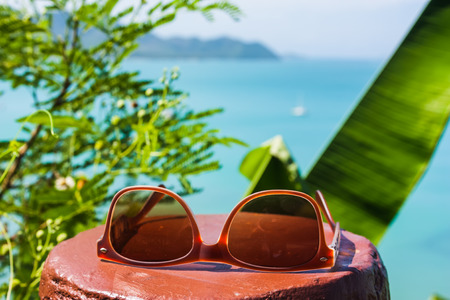 sun glasses on a tropical beach in Thailandの写真素材