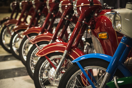 Many multi-colored motorcycles in a rowの写真素材