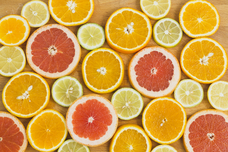 Citrus fruit background with sliced oranges lemons lime tangerines and grapefruit as a symbol of healthy eating and immune system boost with natural vitamins.の写真素材