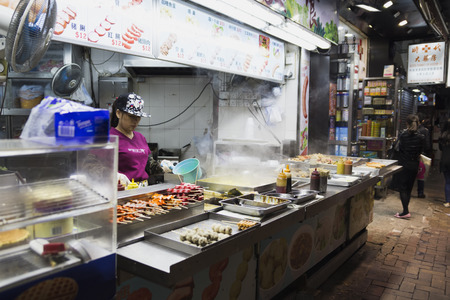 Tasty fried food on a street kitchen in Asia. Fresh vegetables, meat and fish. Hong Kong, China, march 04, 2017のeditorial素材