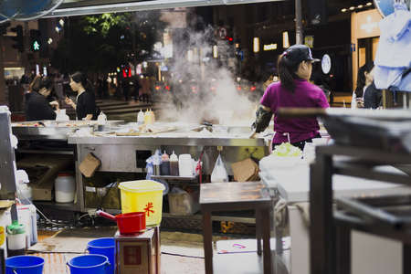Tasty fried food on a street kitchen in Asia. Fresh vegetables, meat and fish. Hong Kong, China, march 04, 2017の写真素材