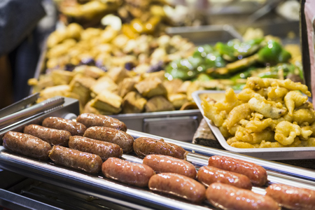 Tasty fried food on a street kitchen in Asia. Fresh vegetables, meat and fish. Hong Kong, Chinaの写真素材