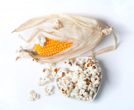 Corn on the cob and pop corn on a white backgroundの写真素材
