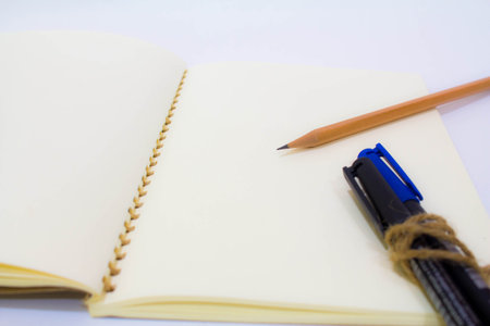 Blank notebook with pen and pencil