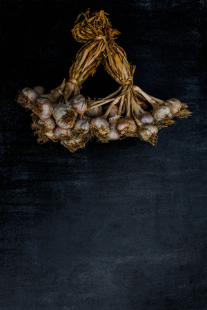 Purple garlic on black wood background,Close upの写真素材
