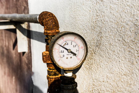 old pressure gauge with rusty, gate valve background and gauges are shown.の写真素材