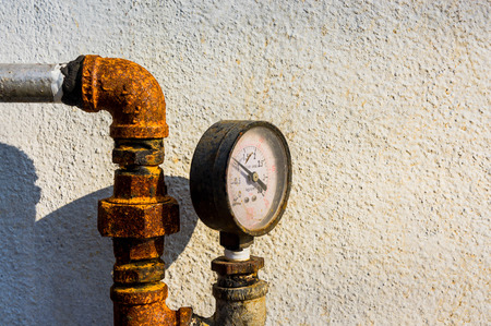 old pressure gauge with rusty, gate valve background and gauges are shown.の写真素材