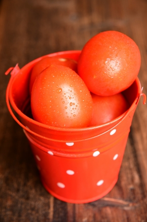 Red tomatoes in a bucketの写真素材
