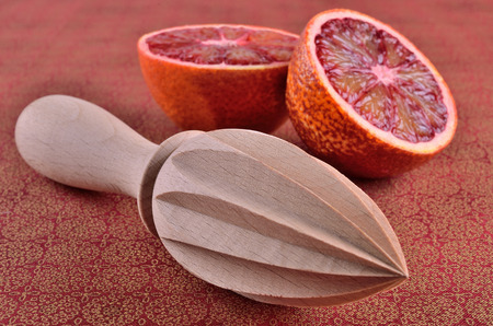 citrus press, lying on a background of cut fruit の写真素材