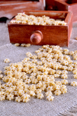 Pasta Stars lying loose on sacking の写真素材