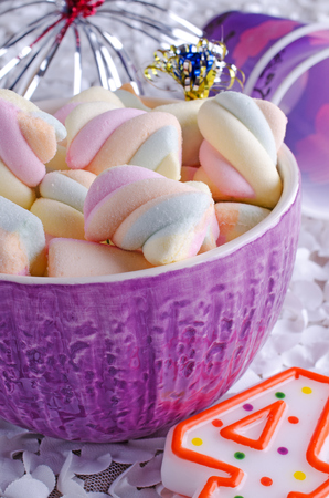 colorful spiral marshmallow lying in ceramic bowlの写真素材