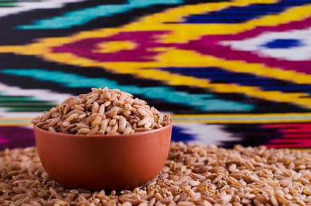 brown grain rice varieties "devzira"scattered on the surfaceの写真素材