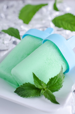 Ice cream in a light green color with a mint leafの写真素材