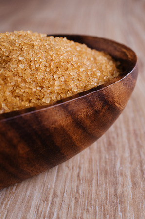 Sugar brown, lying in a wooden bowlの写真素材