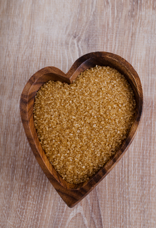 Sugar brown, lying in a wooden bowlの写真素材