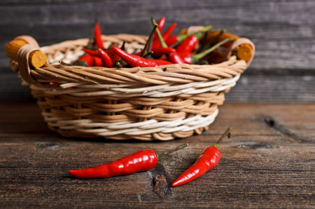 Red fresh pepper on a wooden surfaceの写真素材