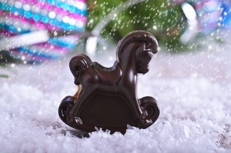 Chocolate curly candy background with Christmas decorationsの写真素材